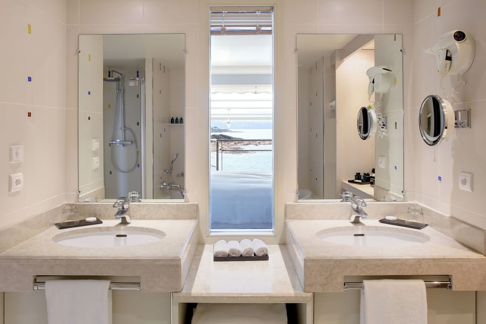 Separate tub and shower, rainfall showerhead, designer toiletries