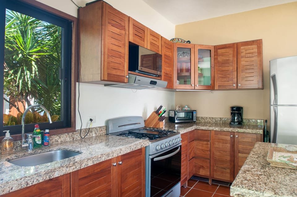 Full size stove - All the comforts of home in this spacious kitchen with granite counter tops and new wood cabinets.