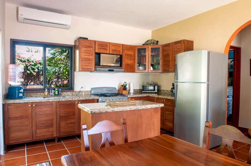 Kitchen with granite - Prepare meals or snacks in this generously equiped kitchen with granite counters, full size gas stove and center island.