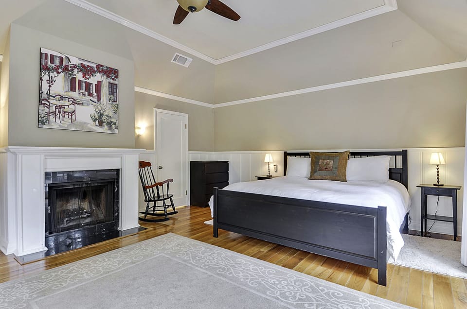 Primary Bedroom on Main Level - King bed with a decorative fireplace.