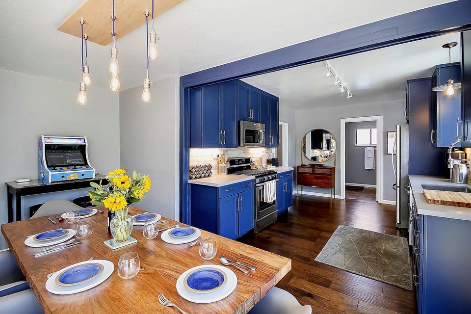 And the kitchen opens to the dining area and living room. The gaming console (a tiny sliver is visible in this photo) is no longer present.