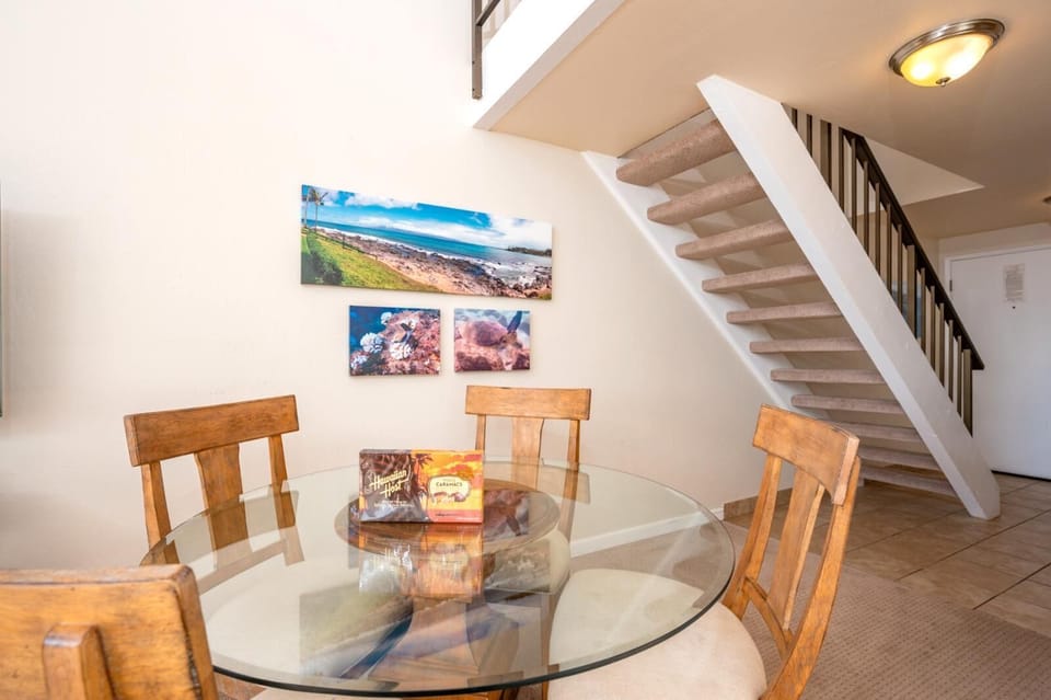 This sunny dining space offers lofted ceilings, modern tropical decor, and a cozy spot to enjoy meals and moments