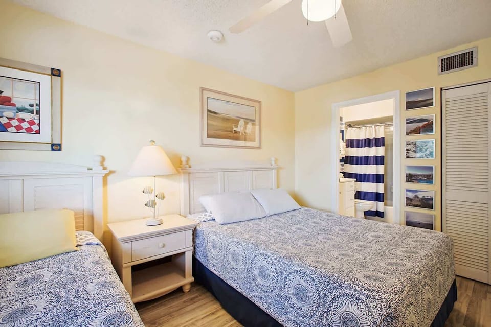 - Enjoy restful nights with both a queen bed and twin bed in this sunny room
- Nautical themed touches, a calming palette, and ocean inspired artwork delight
- Perfect for families or friends who want to share a comfortable space