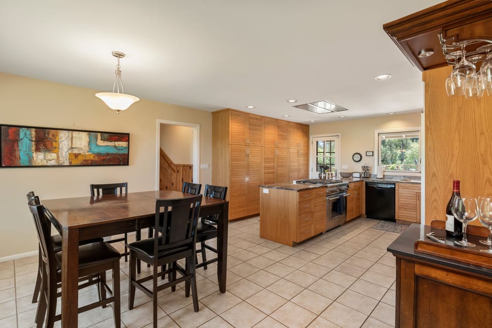 Informal dining in the kitchen area at a raised table and tall chairs also doubles as a 2nd work space if you prefer to stand while you work.