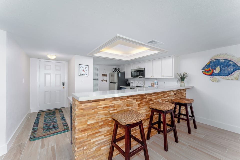 The kitchen bar seats three, making it a handy spot for entertaining the kids or serving up snacks.