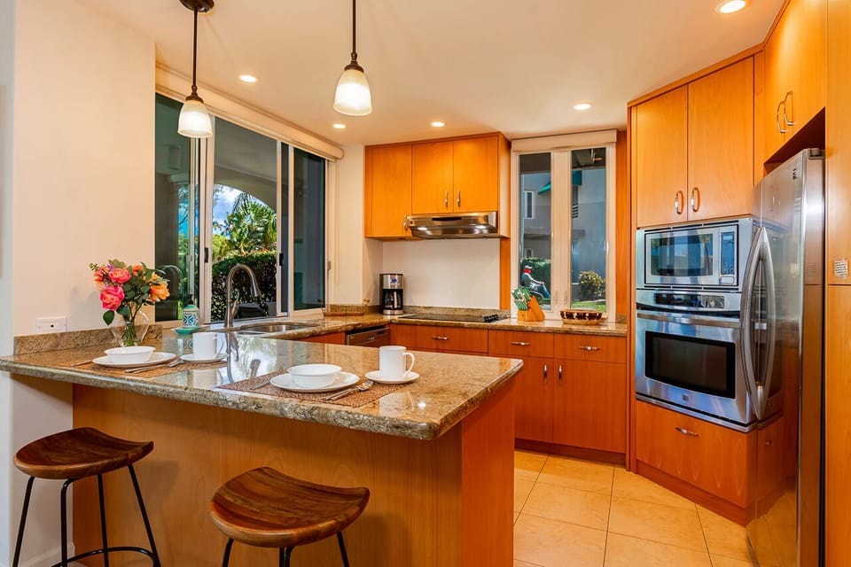 Fully stocked kitchen with a pass through window to the lanai