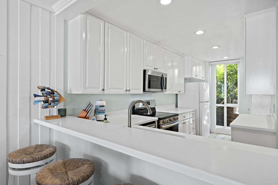 Fully stocked kitchen with bar seating, perfect for breakfast  or evening snacks
