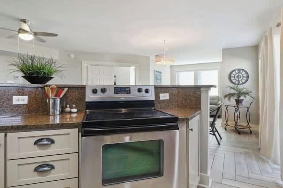 Kitchen with balcony doors to right.