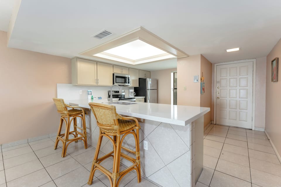 The kitchen and breakfast bar are convenient and filled with light! You'll love working or snacking here!