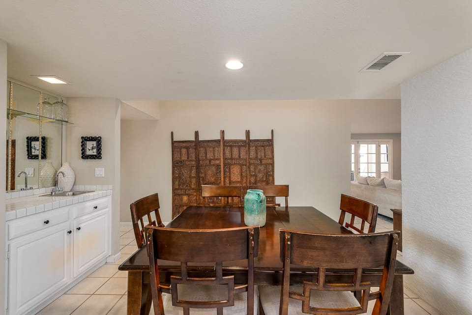 The dining table has a wet bar for convenient access to drinks and platters
