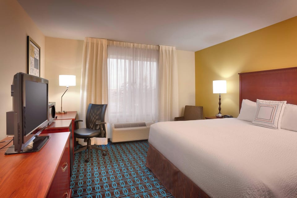 Premium bedding, desk, laptop workspace, blackout drapes
