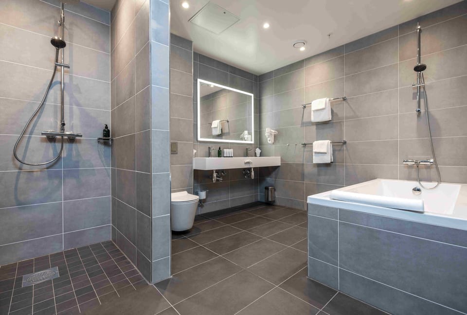 Suite, Non Smoking | Bathroom | Hair dryer, heated floors, towels, soap