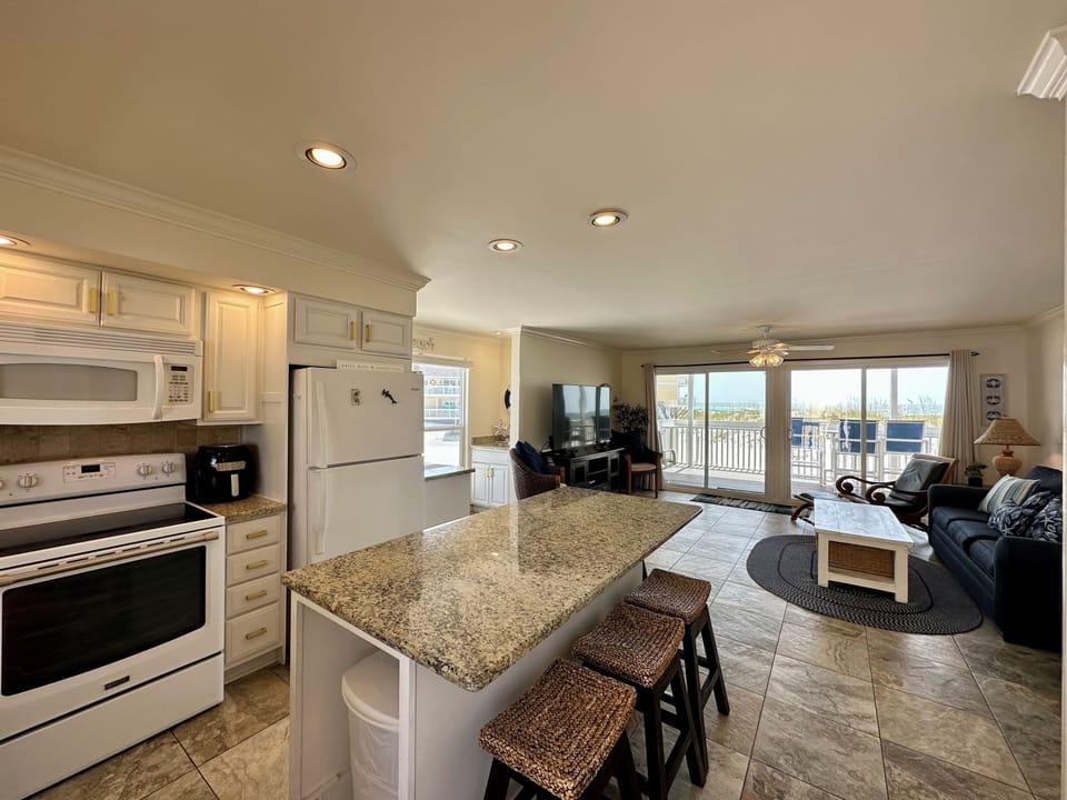 Your open-concept space blends kitchen and living room, with granite counters and balcony access for seamless indoor-outdoor living.