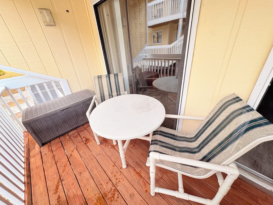 Relax on your private balcony with comfortable seating and a table, perfect for morning coffee or evening conversations.