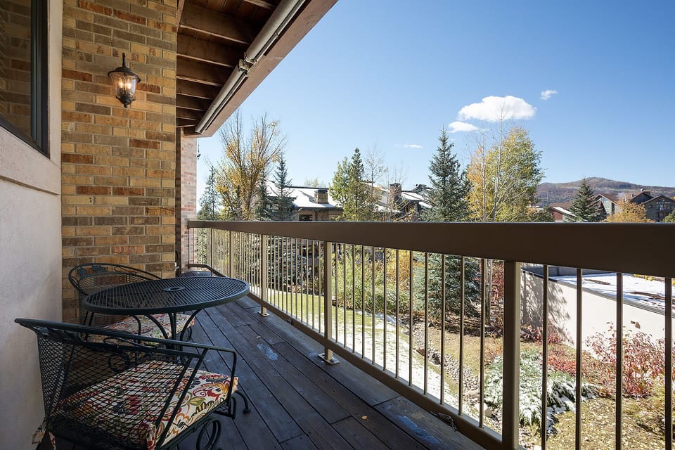 Private balcony overlooks a peaceful residential neighborhood with mountain views and autumn foliage—a perfect spot for morning coffee or evening relaxation.