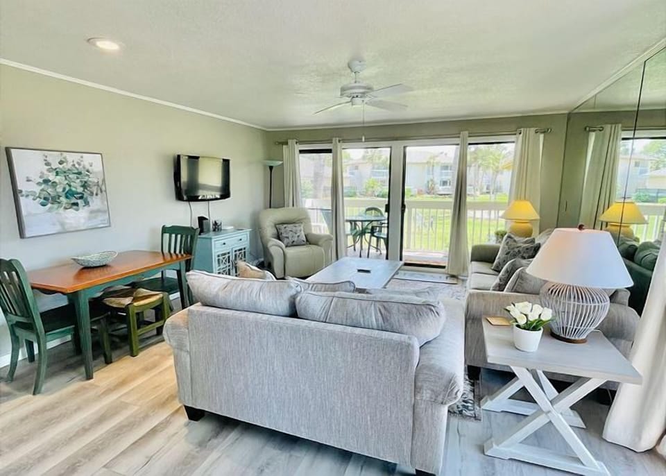 Relax in your bright, open-concept living space with comfortable seating, modern amenities, and peaceful balcony views perfect for unwinding.