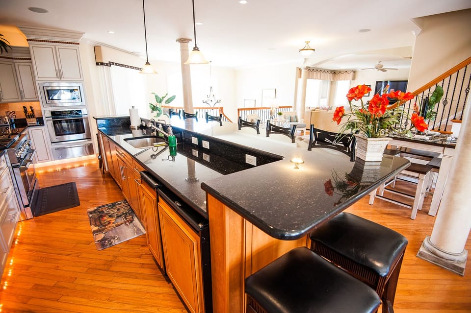 Fabulous granite bar with seating for 10, + beverage refrigerator and ice maker.
