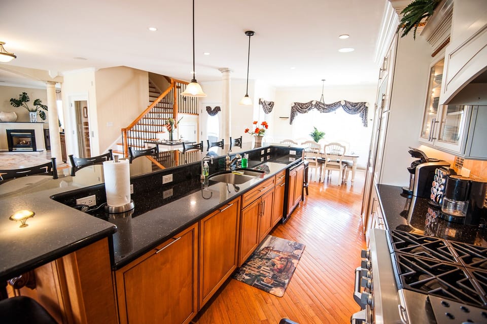 Fabulous granite bar with seating for 10, + beverage refrigerator and ice maker.