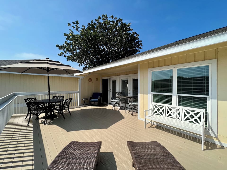 Step onto your private deck where morning coffee and sunset dinners await at the outdoor dining set under shade.