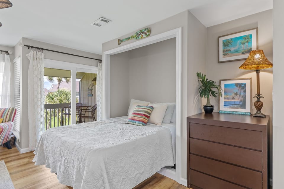 Your clever murphy bed transforms this space instantly, offering flexible living with tropical views from your private balcony.