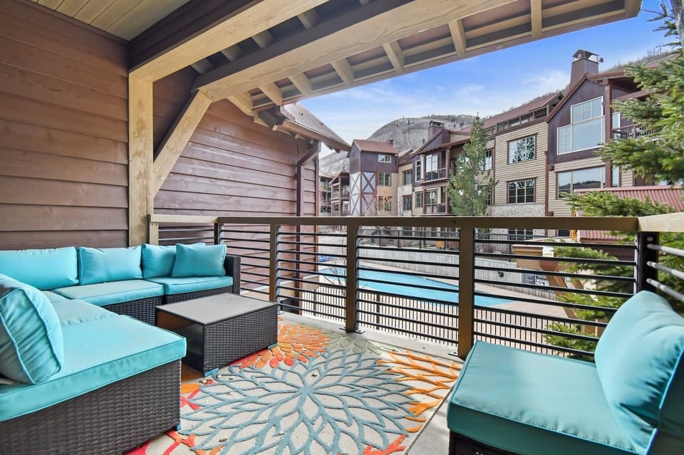 Unwind on your private balcony with plush seating and mountain village views, perfect for morning coffee or evening relaxation.
