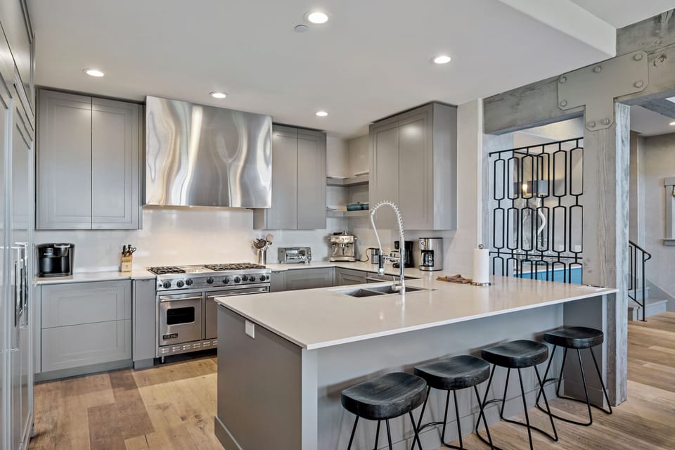 Your gourmet kitchen awaits with sleek granite counters, professional appliances, and stylish bar seating for morning coffee or casual meals.