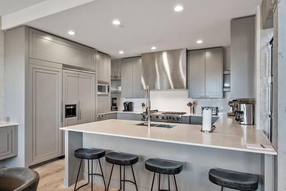 You'll love cooking in this sleek modern kitchen with premium appliances, spacious island, and stylish bar seating for casual dining.