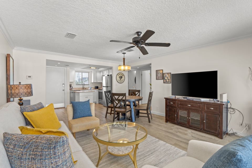 Relax in your bright, open-concept living space with modern furnishings, full kitchen access, and entertainment center for comfortable stays.