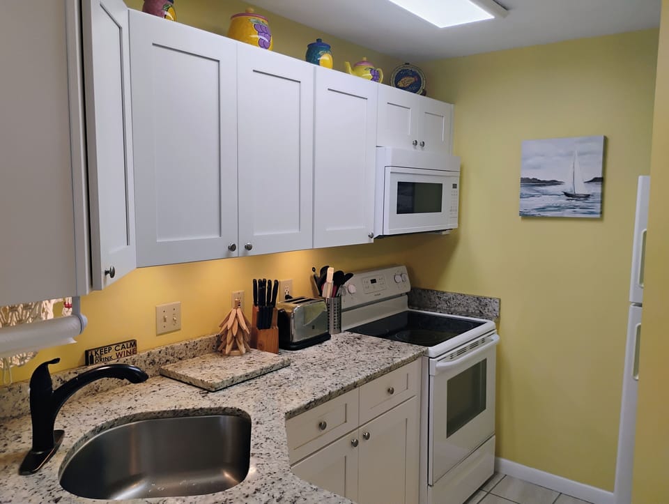 Your fully-equipped kitchen awaits with granite counters, modern appliances, and everything needed to prepare delicious meals during your stay.