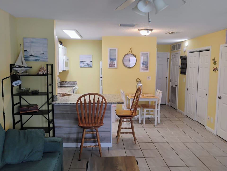 Your bright coastal retreat features an open layout where kitchen, dining, and living areas flow together perfectly for relaxed vacation living.