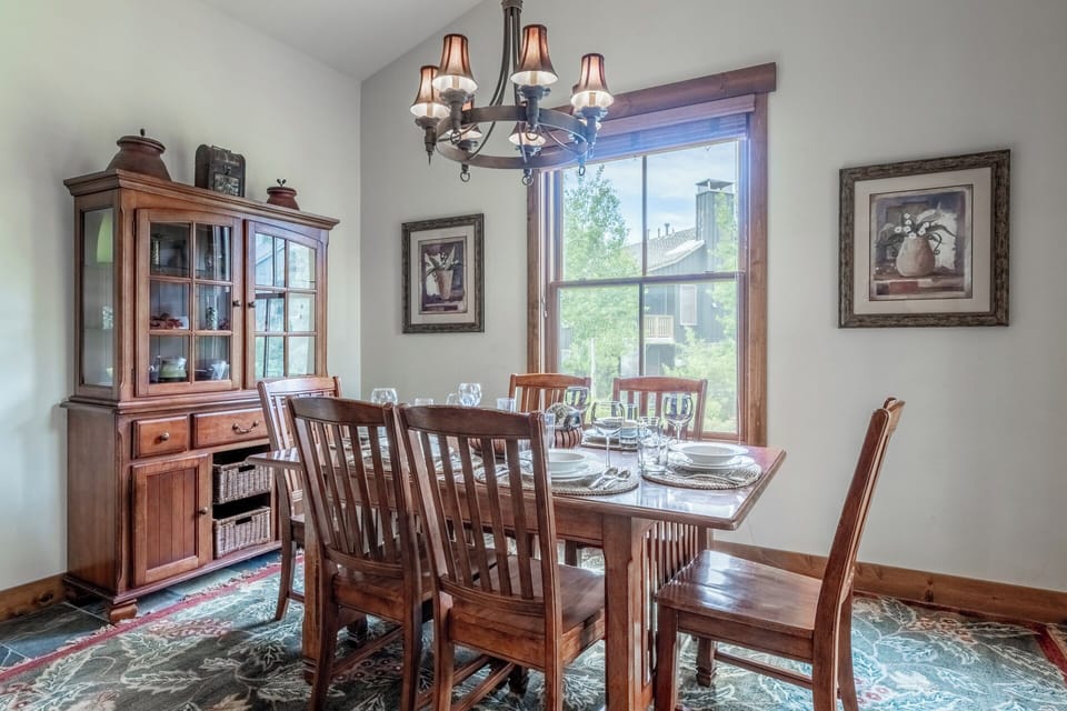 Gather around this elegant dining table where warm wood tones and mountain views create the perfect backdrop for your memorable meals together.