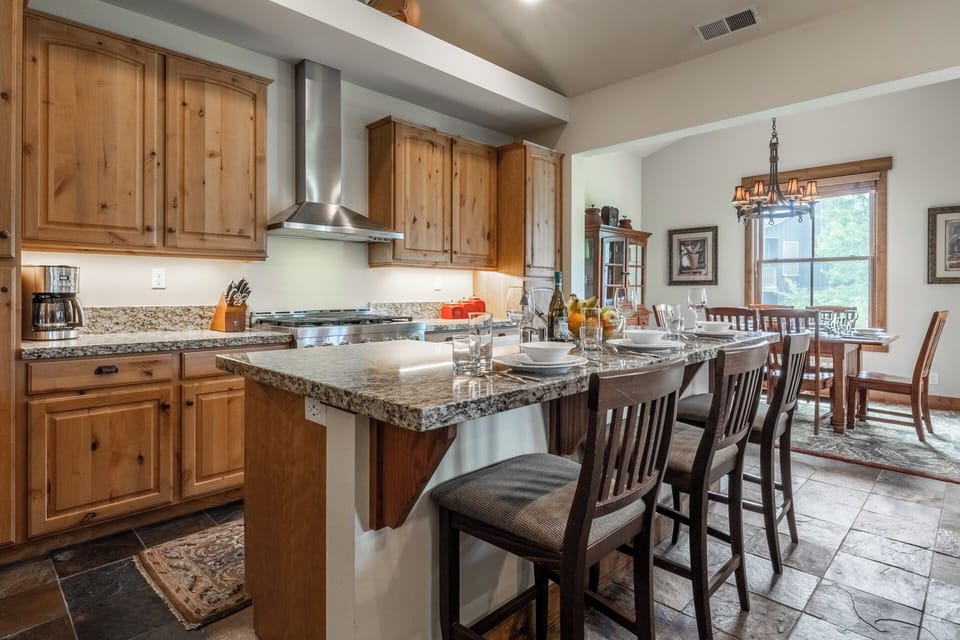 Gather around your spacious kitchen island with granite countertops and modern appliances, where meal prep becomes a shared experience. The open layout flows into the dining area, perfect for memorable group dinners.