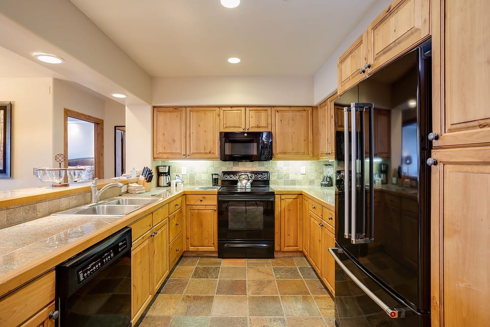 Your spacious kitchen features warm wood cabinets, modern appliances, and everything needed to prepare memorable vacation meals together.