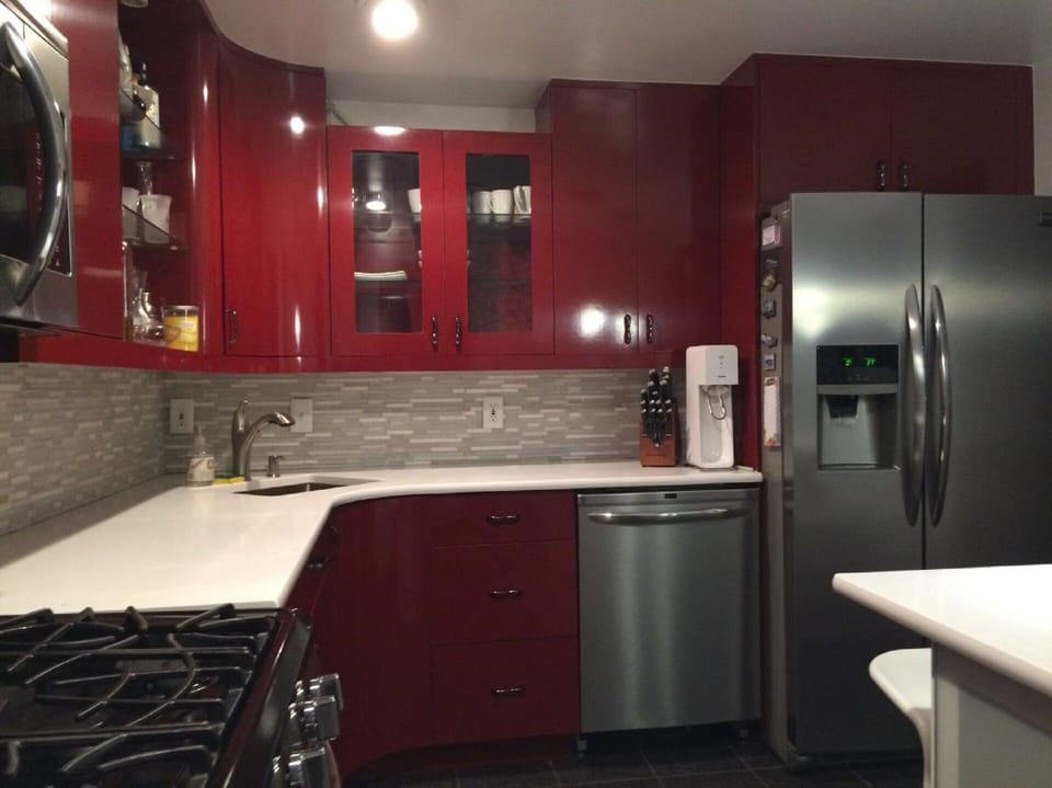 Modern red cabinets with plenty of storage and all essential cookware 