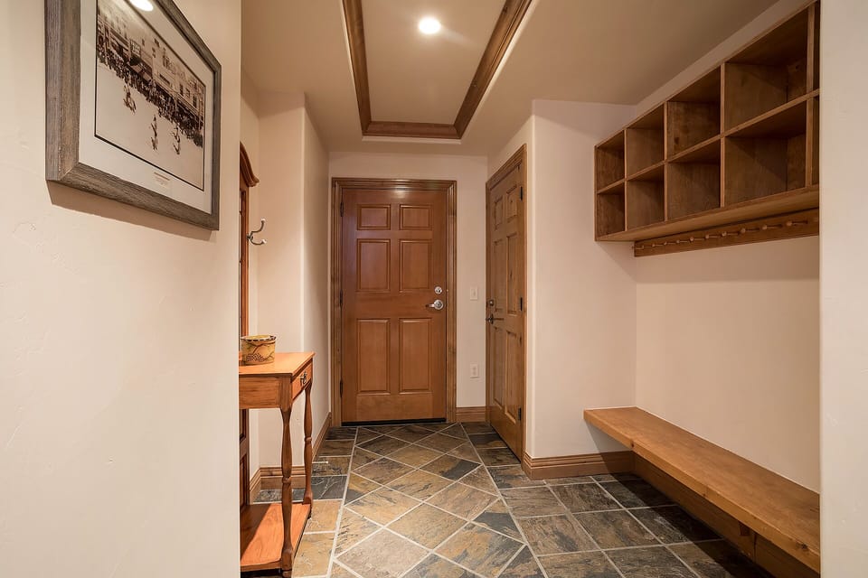 Your arrival space welcomes you with warm wood details and built-in cubbies for effortless organization.