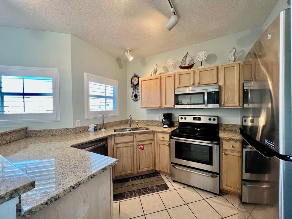 Your fully equipped kitchen features granite countertops, stainless steel appliances, and everything needed to prepare meals during your stay.