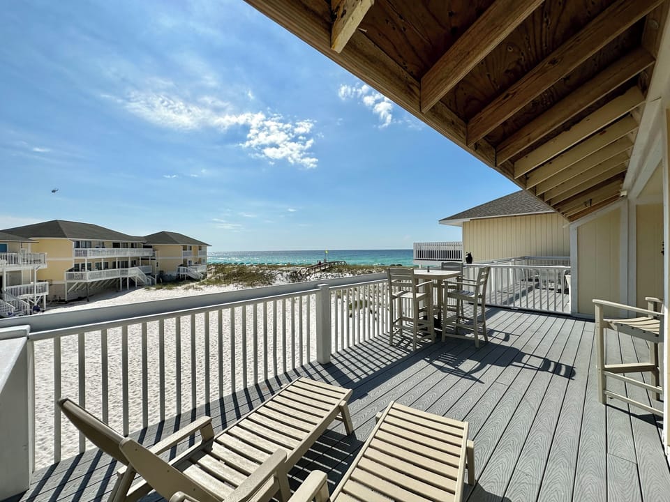 Soak up panoramic ocean views from your private beachfront balcony, complete with comfortable seating for morning coffee and sunset moments.