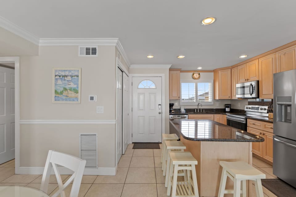 Discover your fully equipped kitchen with granite counters, stainless appliances, and breakfast bar—perfect for creating memorable meals together.