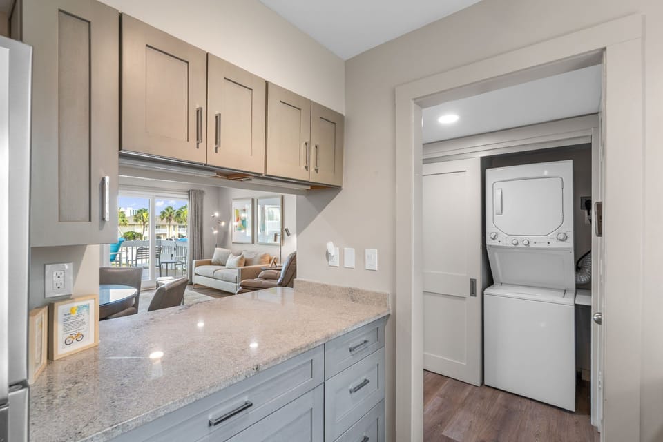 Sleek countertops and modern cabinetry make it easy to keep your space organized, with convenient in-unit laundry just steps away.