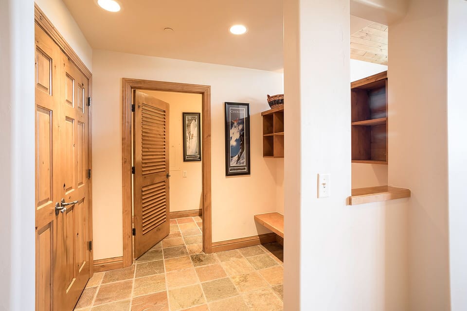 Your private entry mudroom features built-in benches and cubbies to organize gear after mountain adventures.