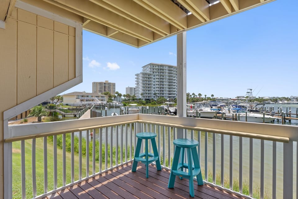 Sip your morning coffee on your private balcony while watching boats glide through the marina below, with coastal views stretching beyond.
