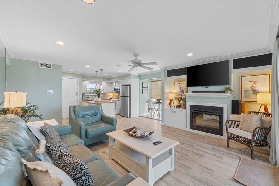 Unwind in your coastal-inspired living room where soft blue furnishings and warm lighting create the perfect retreat after beach days.