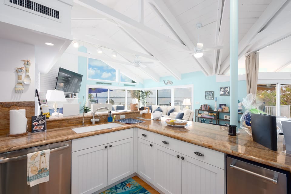 Kitchen with raised breakfast bar and granite countertops