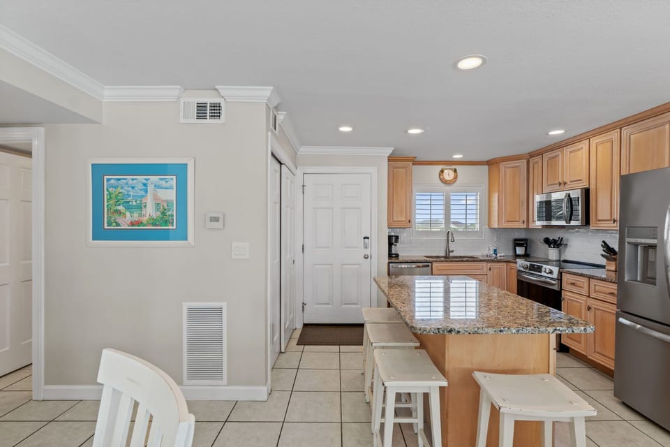 Whip up your favorite meals in this fully-equipped kitchen featuring granite countertops, stainless steel appliances, and breakfast bar seating.