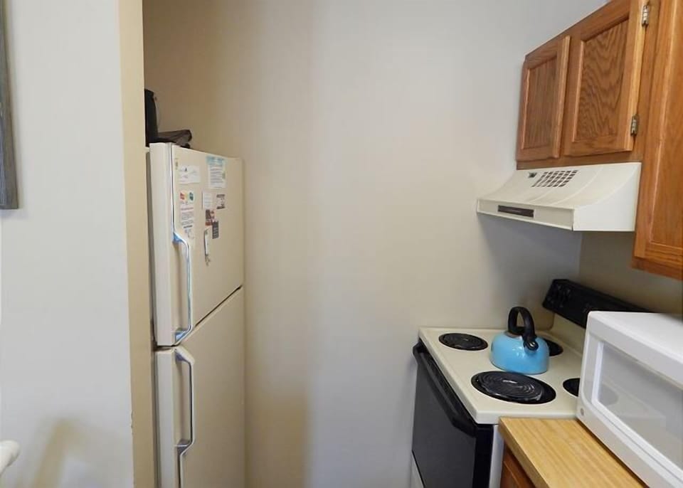 Your fully equipped kitchen features everything you need, including a refrigerator, stove, microwave, and ample storage space for home-cooked meals.