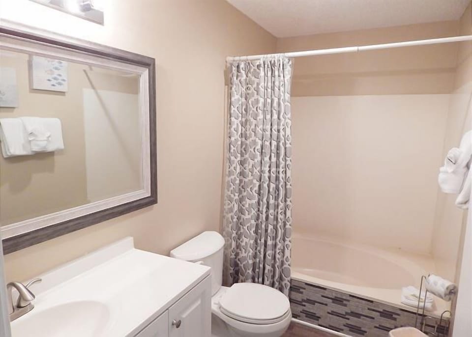 Your private bathroom features a spacious shower-tub combo, stylish vanity, and thoughtful touches that make your daily routine feel luxurious.