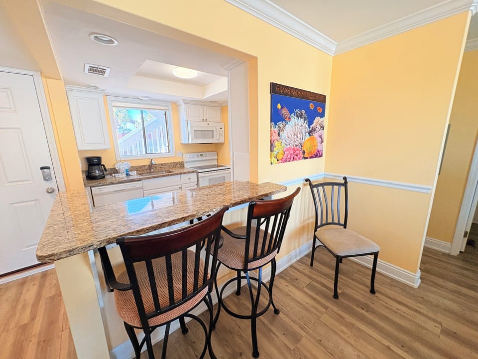 Your open-concept kitchen and dining area features granite countertops, modern appliances, and comfortable seating for memorable meals together.