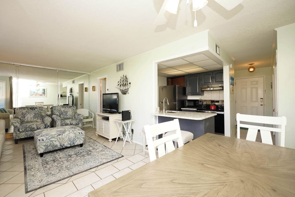Relax in your spacious open-plan living area with comfortable seating and a fully equipped kitchen for home-cooked meals.