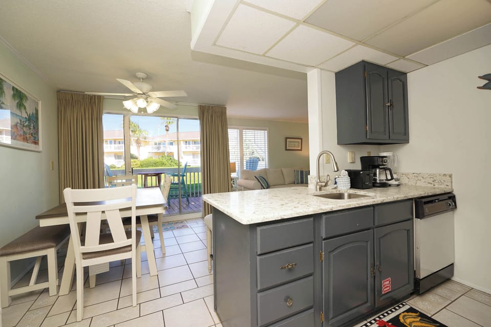 Your fully equipped kitchen flows into a bright dining space with balcony views, perfect for morning coffee or preparing fresh meals.