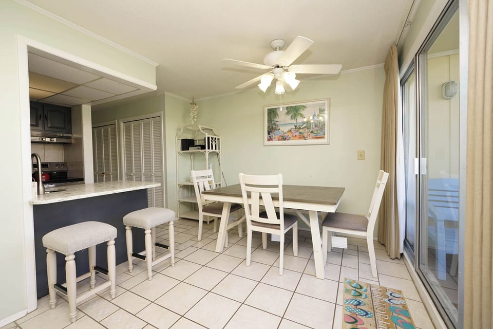 Your bright dining space flows seamlessly into the well-equipped kitchen, creating the perfect spot for memorable meals together.